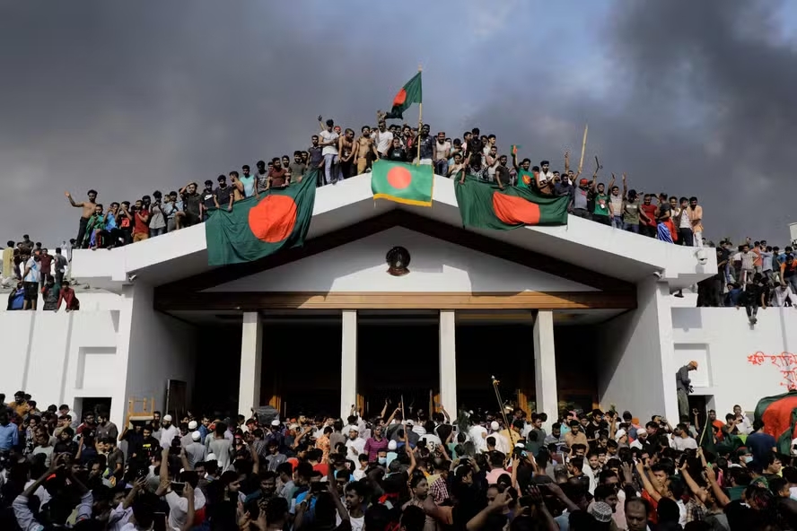 108011160 topshot anti government protestors display bangladeshs national flag as they storm prim